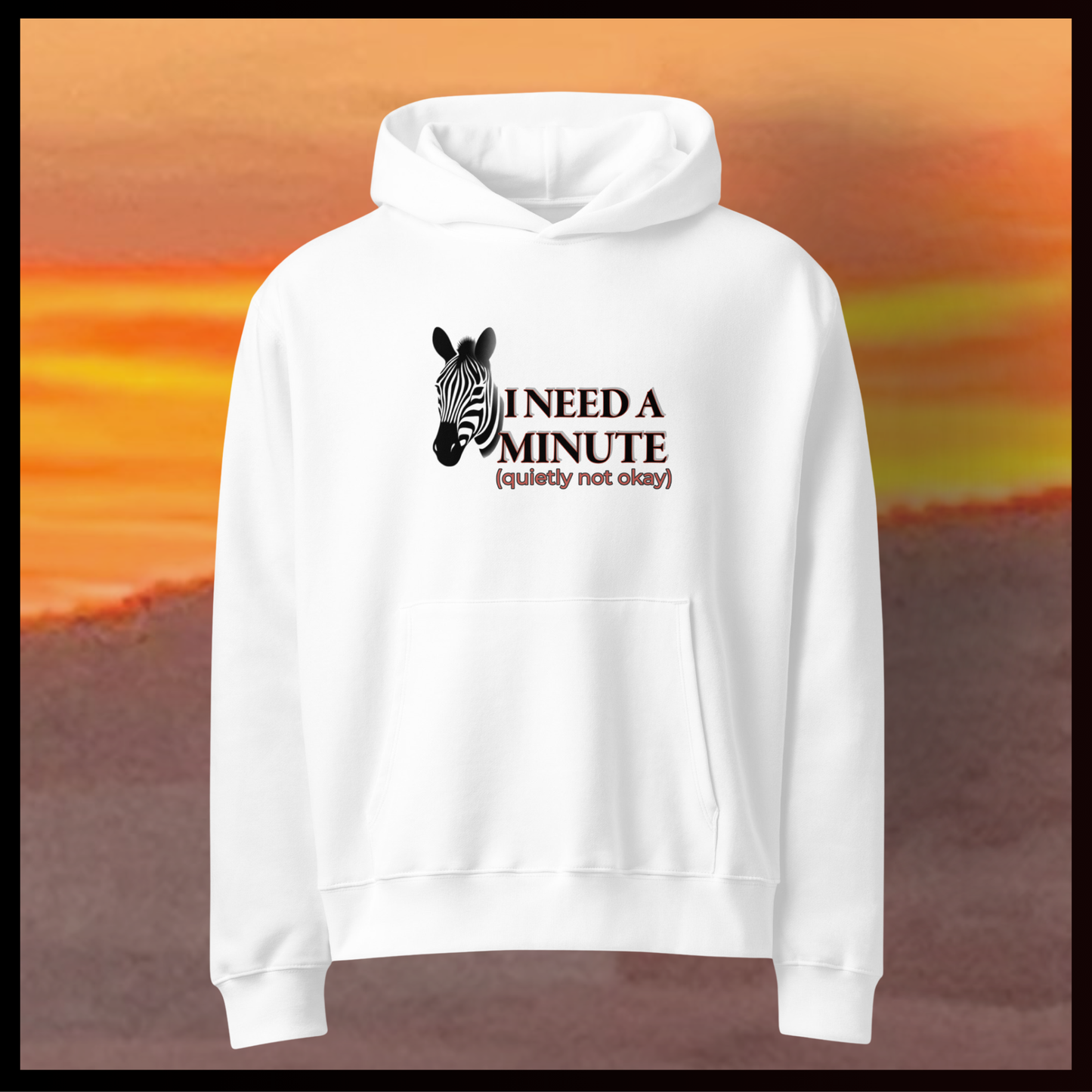White hoodie with zebra graphic and text on a blurred sunset background