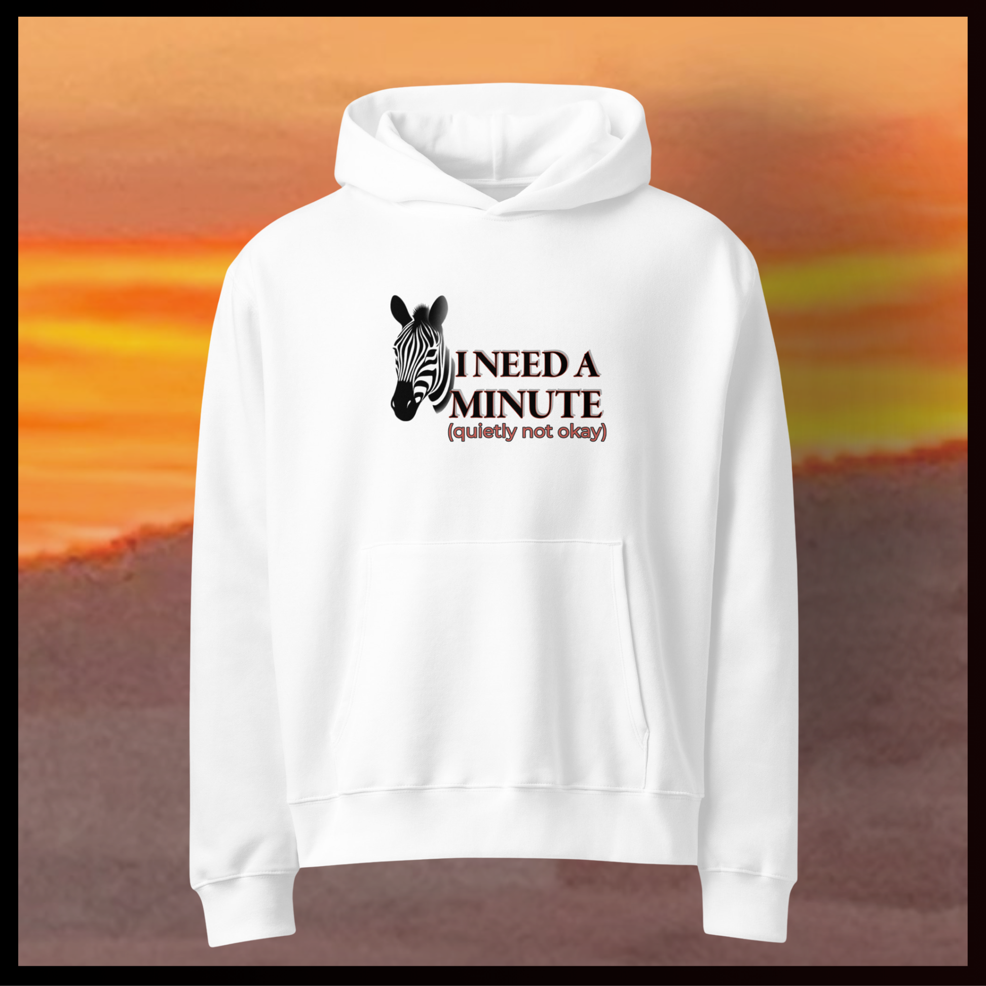 White hoodie with zebra graphic and text on a blurred sunset background