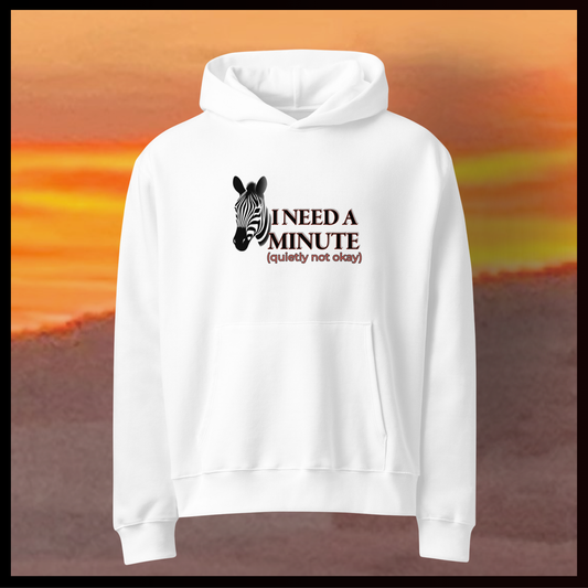 White hoodie with zebra graphic and text on a blurred sunset background