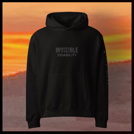 Black hoodie with 'INVISIBLE DISABILITY' text against a desert background