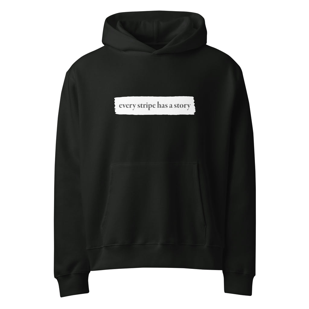 Black rare disease hoodie with text 'every stripe has a story' on a white background